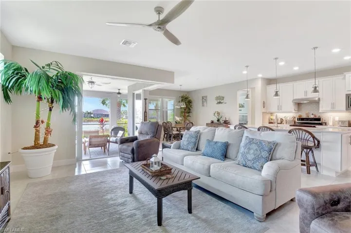 Living room with light tile patterned floors and ceiling fan