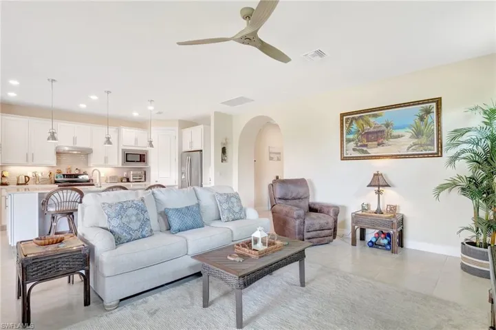 Tiled living room with sink and ceiling fan