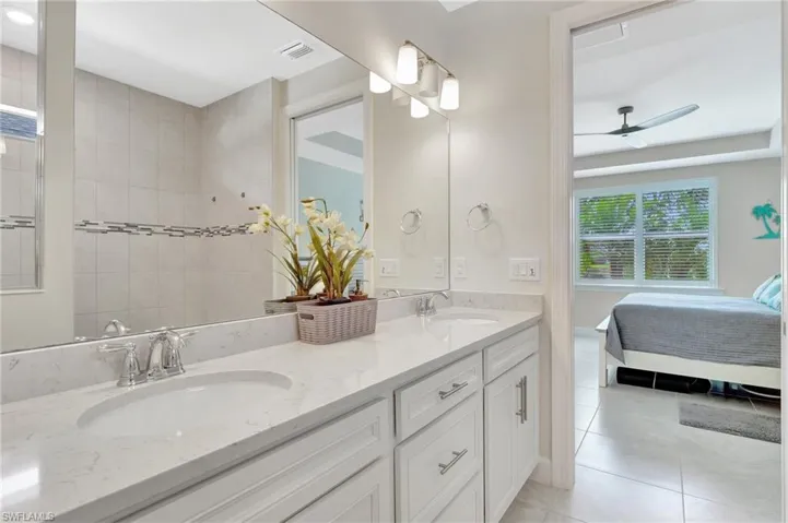 Bathroom featuring ceiling fan, tile patterned flooring, and vanity