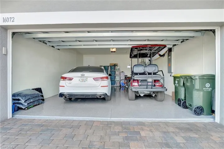 Garage featuring a garage door opener and electric panel