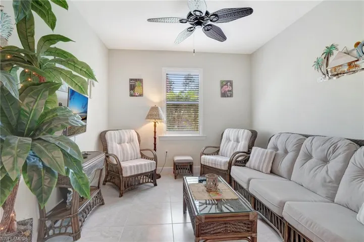Tiled living room featuring ceiling fan