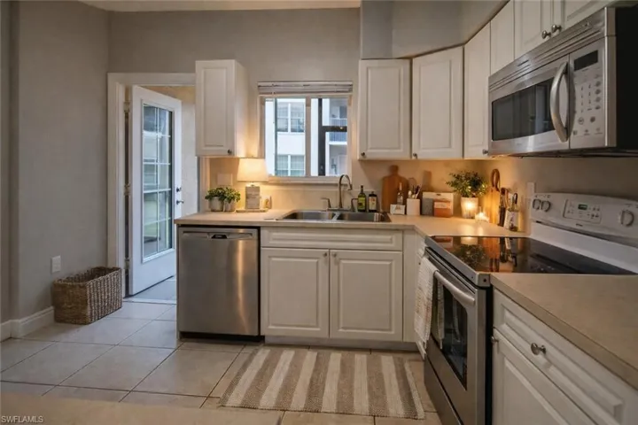 Kitchen featuring stainless steel appliances and white cabinetry