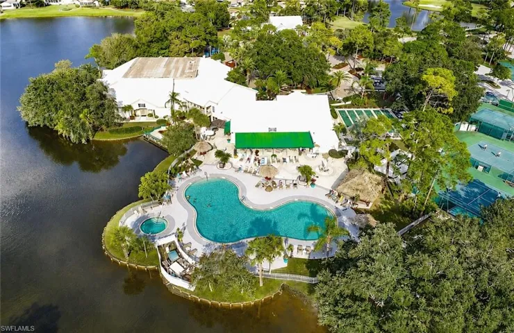 Expansive resort-style pool area featuring a freeform swimming pool, integrated spa, and multiple lounging spaces