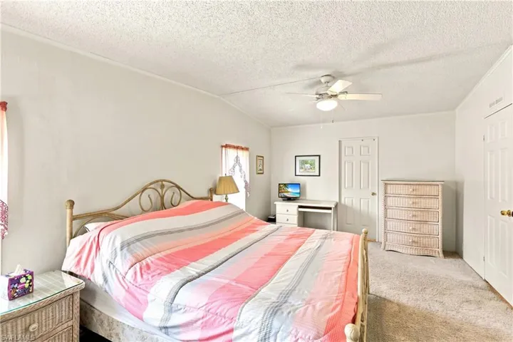Bedroom featuring wall-to-wall carpeting and a ceiling fan with integrated lighting