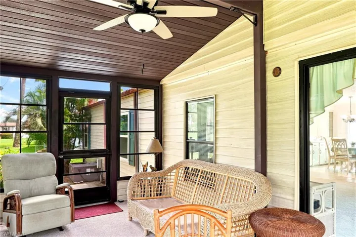Screened patio featuring a ceiling fan with integrated lighting, wood-finish ceiling, and ample natural light through multiple windows