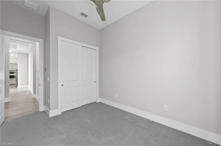 Unfurnished bedroom with carpet floors and a closet