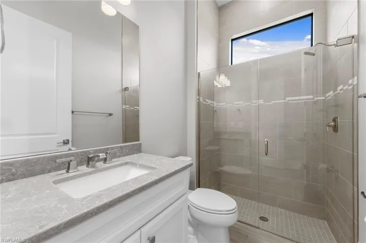 Bathroom with vanity and a stall shower