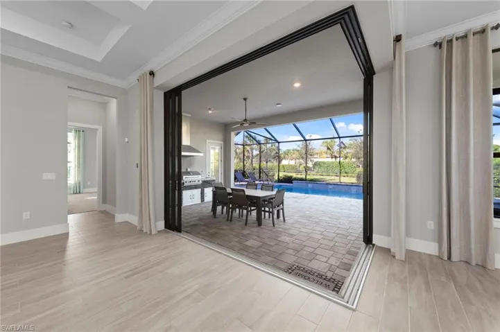 Dining room with a sunroom, ornamental molding, wood finish floors, and ceiling fan