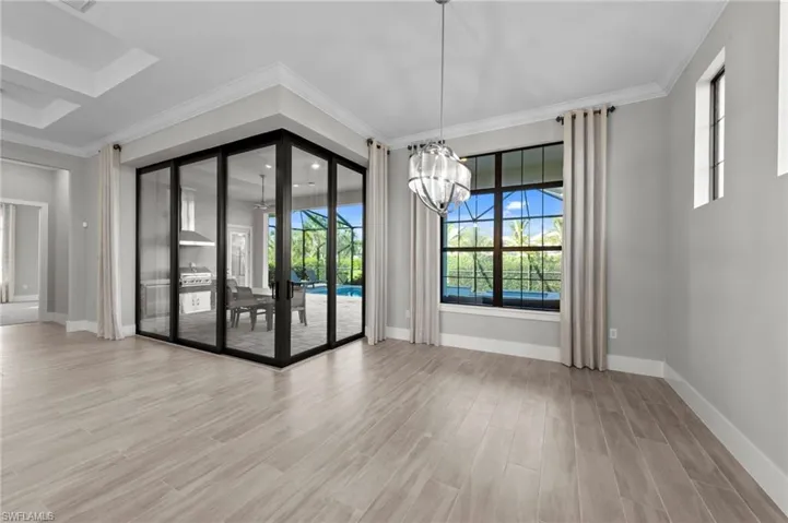 Unfurnished dining area with crown molding, light wood-type flooring, and a chandelier