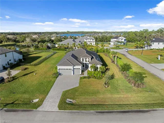 Aerial perspective of suburban area featuring a large body of water