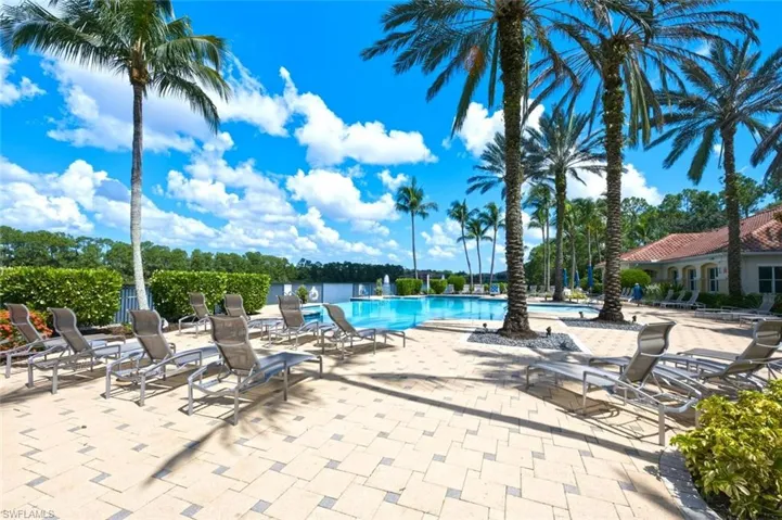 Expansive paver patio surrounding a pool with integrated water features
