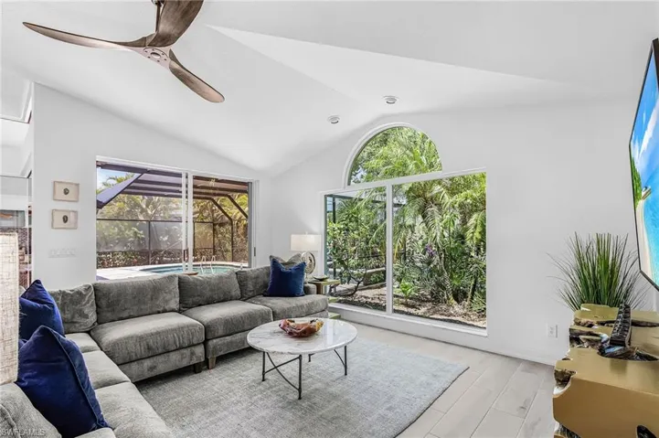 Vaulted ceilings, huge palladium window and light wood-finish flooring define this cozy space