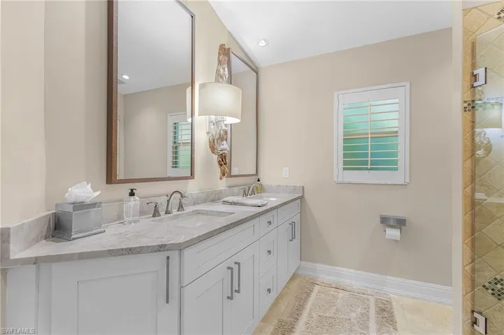 Guest Bathroom featuring a dual vanity with stone countertop