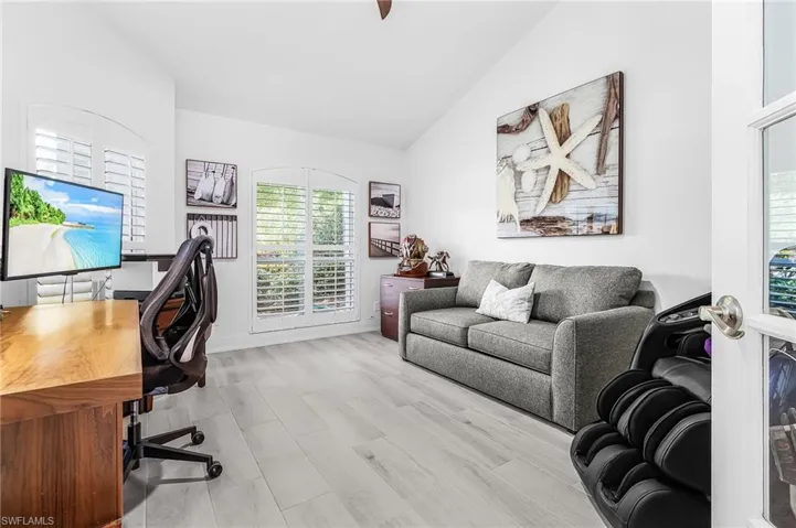 Home office or 4th Bedroom with wood-finish tile flooring and vaulted ceilings