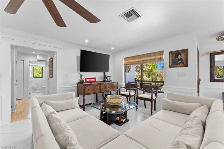 Living area featuring plenty of natural light, recessed lighting, a ceiling fan, and light wood-style flooring