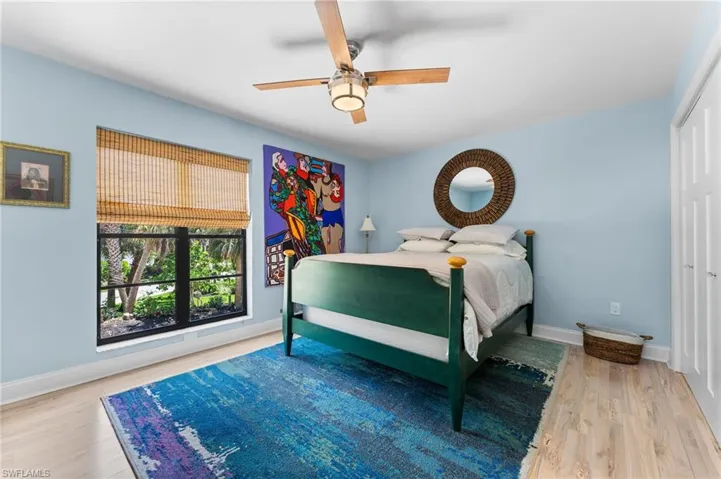 Bedroom featuring ceiling fan and light wood-type flooring