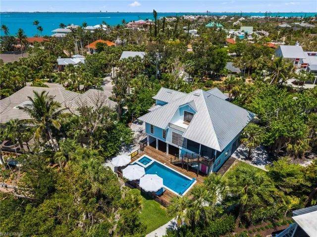 Bird's eye view of a pool area and a nearby body of water