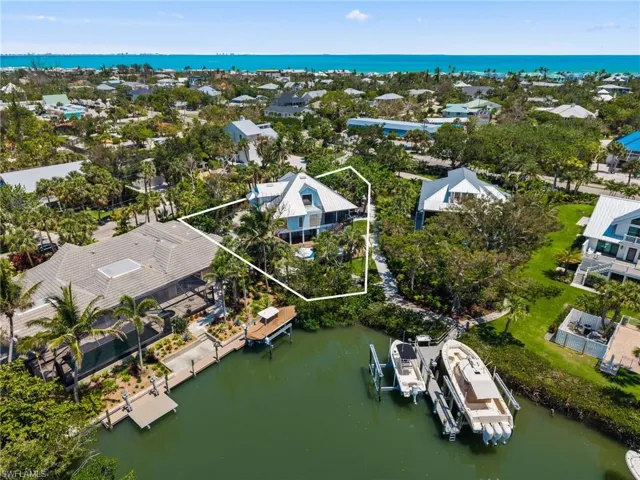 Aerial perspective of suburban area with a nearby body of water