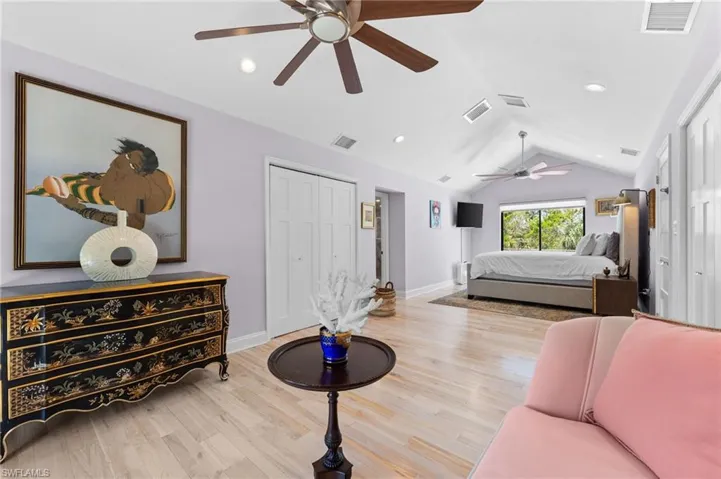 Bedroom featuring lofted ceiling, light wood-style floors, ceiling fan, recessed lighting, and a closet