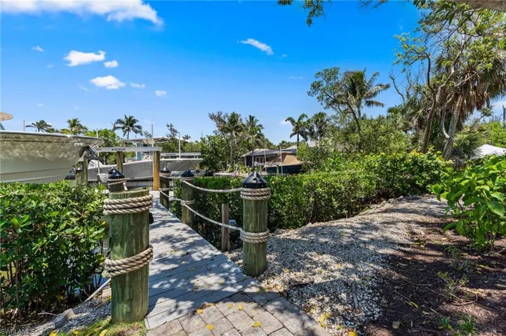 View of property's community with a dock and boat lift