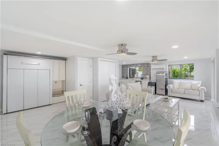 Dining room featuring light tile finish flooring, recessed lighting, and a ceiling fan - Virtually Edited Image