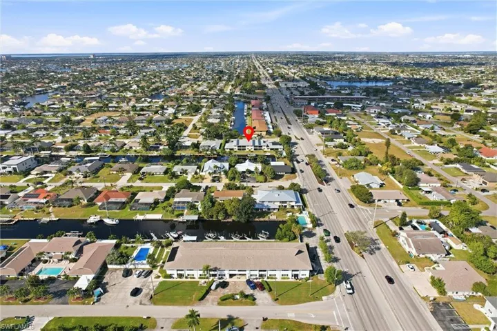 Aerial overview of property's location featuring nearby suburban area and a nearby body of water