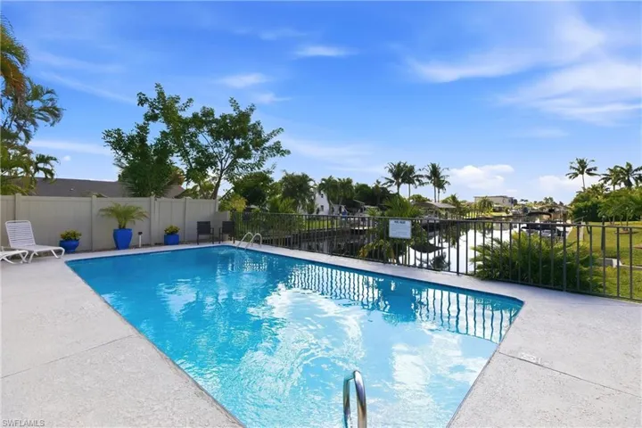 View of swimming pool with a patio area and a water view