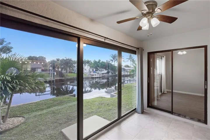 Unfurnished sunroom with a water view