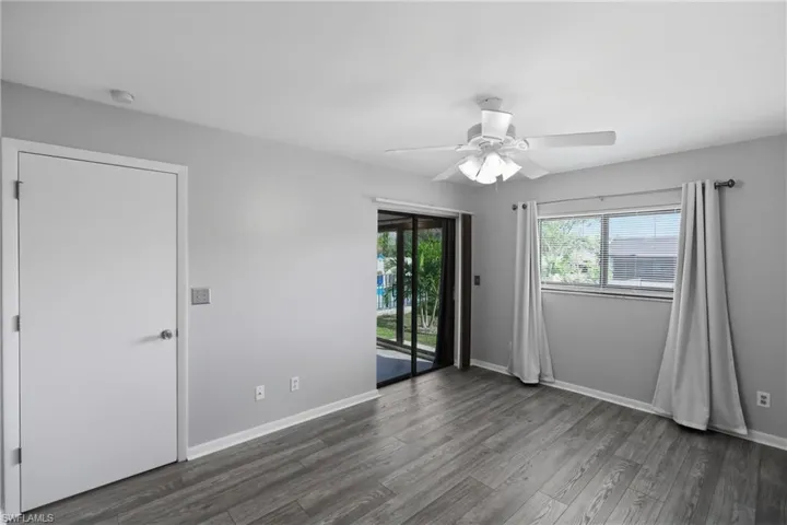 Unfurnished room with wood finished floors and a ceiling fan