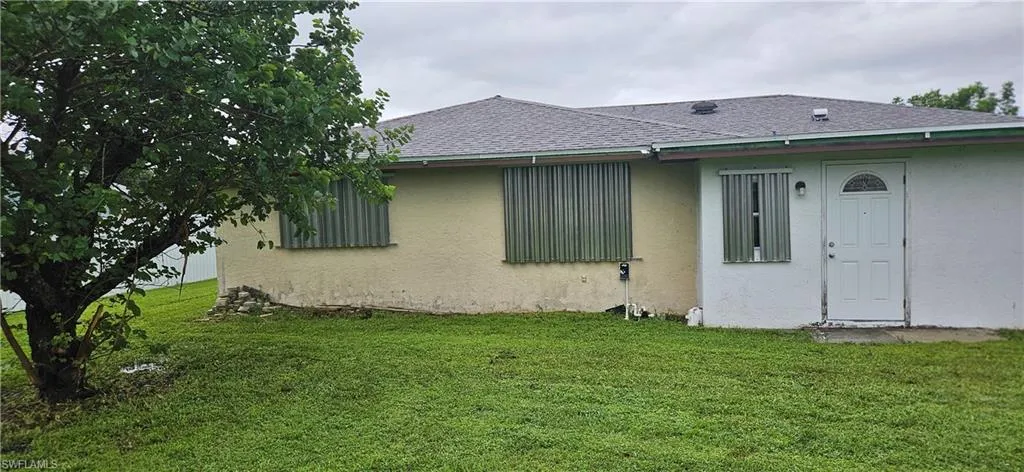 Rear view of house with a lawn