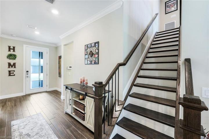 Gorgeous open staircase with wood stairs and wrought iron balusters is a great focal point in the home and leads to the spacious loft which has an additional family room, bedroom and bath. The perfect space for guests.