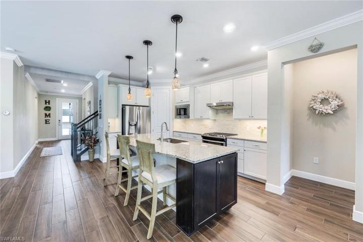 You'll love this home with the open floor plan featuring a spacious kitchen, wood look plank tile flooring and crown molding. A great gathering space for friends and family.