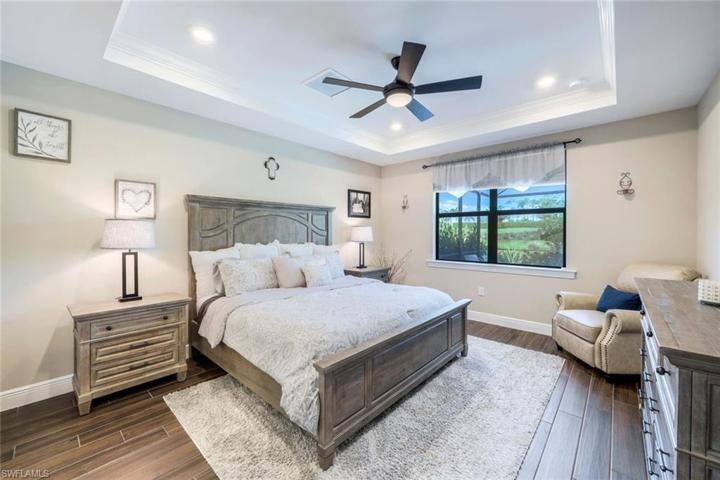 Spacious master bedroom on first floor, with beautiful views of the pool/spa and lake beyond.