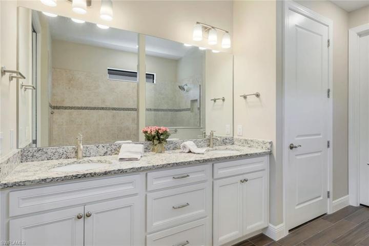 Owner's suite bath includes dual sinks, walk-in shower, and a large walk-in closet.