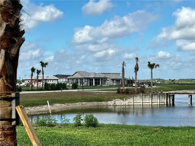 View of pond, golf course, pool & bar