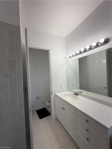 Full bathroom featuring vanity and light tile patterned floors
