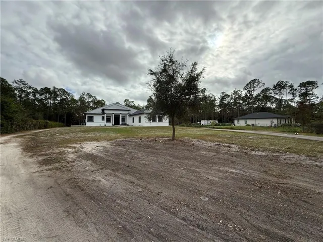 Single story home featuring a front lawn