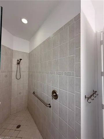 Bathroom featuring a tile shower and recessed lighting