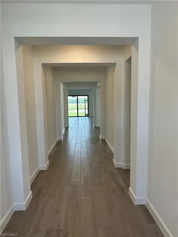 Hallway featuring dark hardwood / wood-style floors