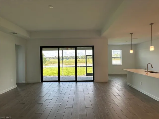Spare room with sink and dark hardwood / wood-style flooring