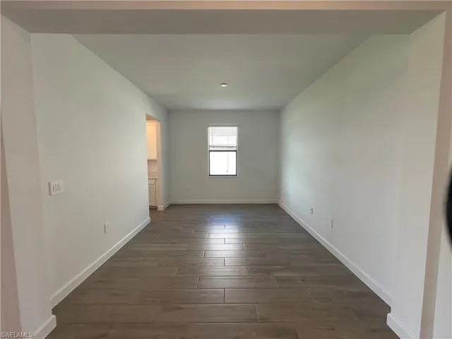 Spare room with dark hardwood / wood-style floors