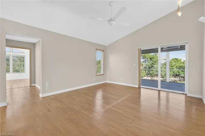 Bedroom featuring healthy amount of natural light, light wood finished floors, a ceiling fan, and high vaulted ceiling
