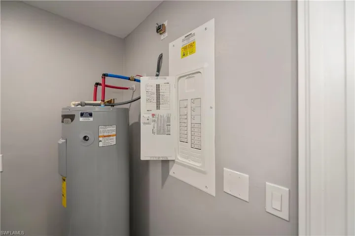 Utility room with electric panel and water heater
