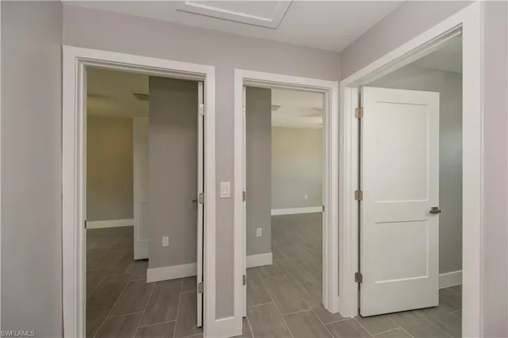 Hallway with visible vents and baseboards