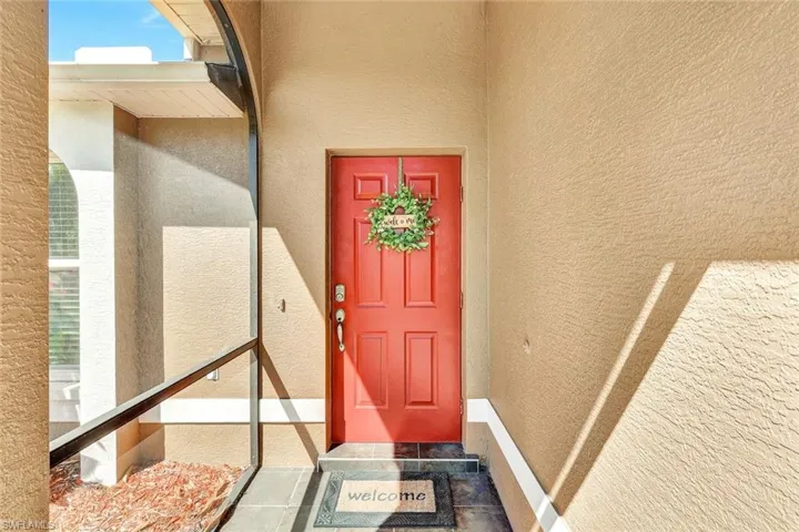 View of exterior entry with stucco siding
