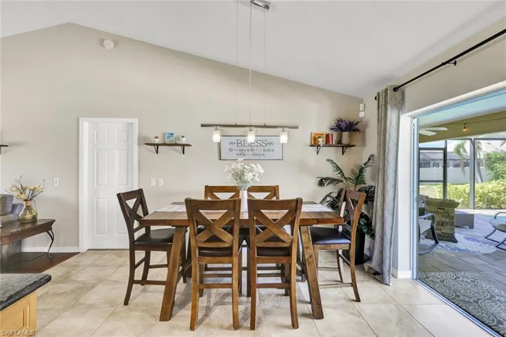 Dining space featuring vaulted ceiling and baseboards