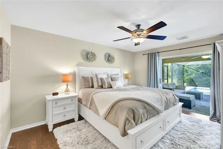 Bedroom with access to outside, wood finished floors, and a ceiling fan