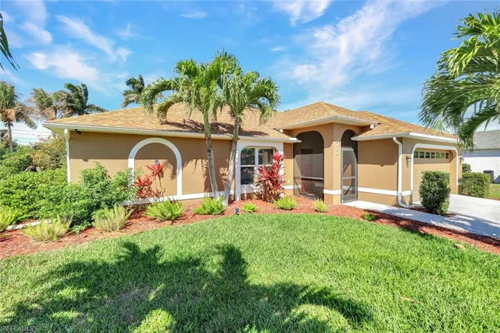 Mediterranean / spanish-style house with a garage, stucco siding, a front yard, a sunroom, and a shingled roof