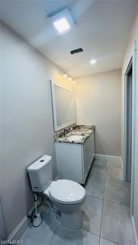 Half bath featuring toilet and vanity