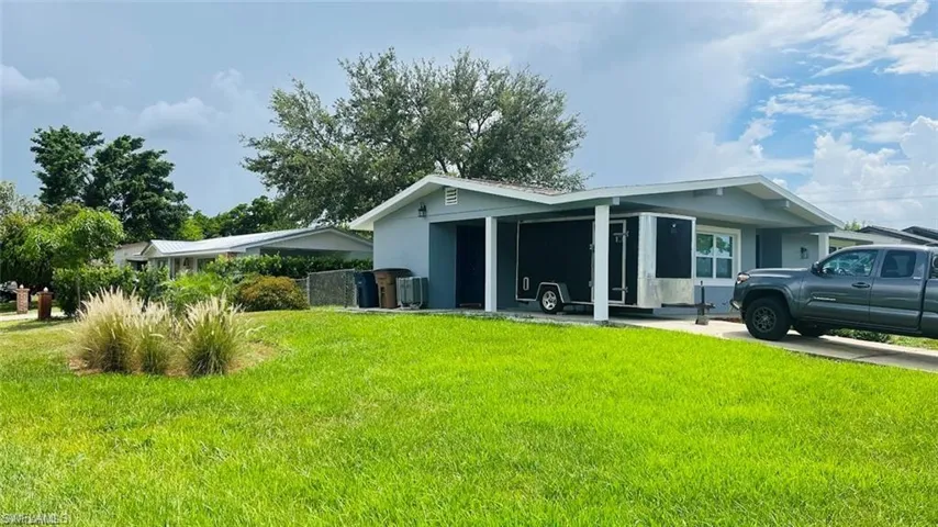 Rear view of property featuring a lawn